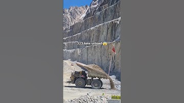 Mining trucks unload 323 tons of material #dumptruck