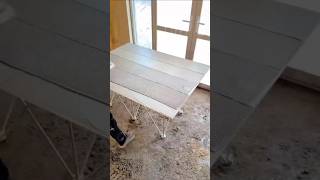 Lifting large format ceramic tile for installation on floor using thinset