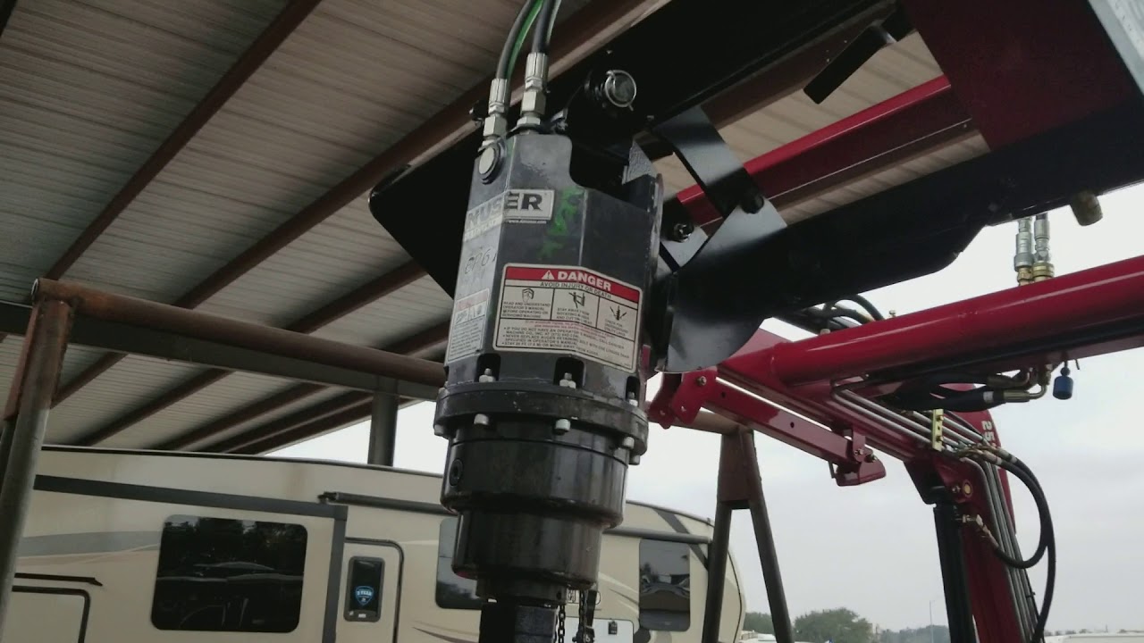 Skid steer post hole digger on a Mahindra 2538 YouTube
