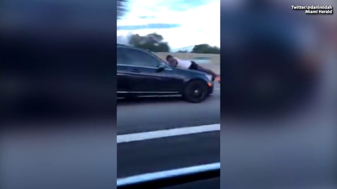 WATCH Man Caught Riding on Hood of Car on Major Highway YouTube