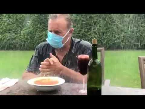 A Man Drinking In The Rain/A man seen drinking and taking soup while it ...