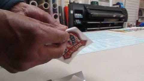 Removing sticker from backing paper