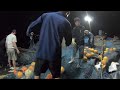 Fishermen catching fish in the sea with a big net on a boat