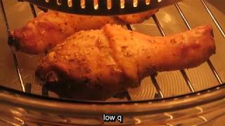 Cooking chicken drumsticks using halogen oven. Closeup