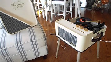 Magnavox record player playing a stack of 45 records