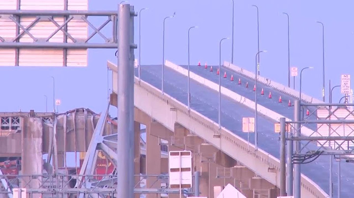 Sunrise shows damage to Baltimore bridge after being rammed by container ship