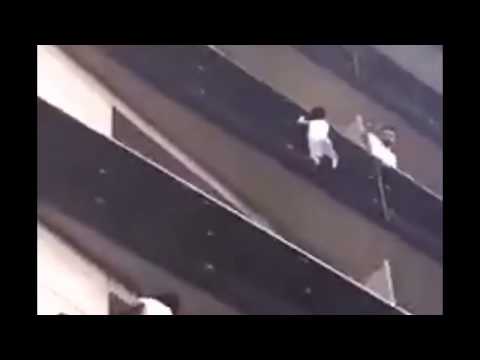 A young man in Paris climbs up to a balcony to save a child from falling