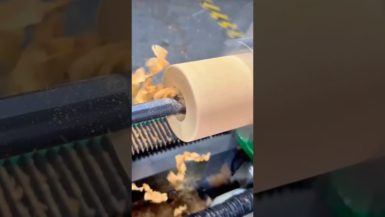 Precision woodturning process creating a smooth cylindrical shape on a lathe machine