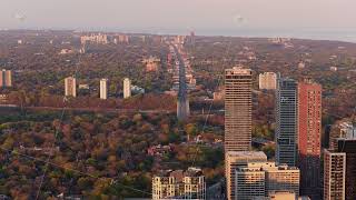 Warm light from sunset illuminating Toronto's cityscape with Yonge Street reaching towards Lake