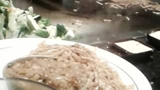 Guy cooks food in front of us at chi tung