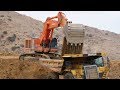 Hitachi EX1200 Excavtor loading Cat 777 Trucks