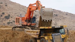 Hitachi EX1200 Excavtor loading Cat 777 Trucks