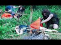 Primitive life forest man meets a ethnic girl catching big fish by the stream  eating delicious