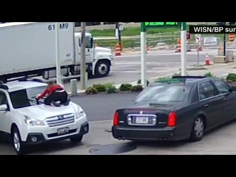 Woman jumps on hood of car to stop thief