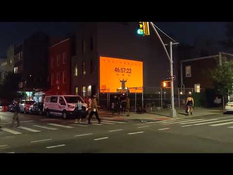 projects The Weeknd on a downtown building for major visibility