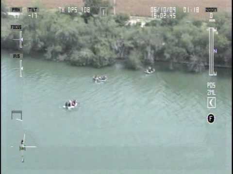 DPS Aviation video shows drug smugglers as they drive their pick-up truck, which is loaded with marijuana, into the Rio Grande River following a pursuit with US law enforcement. The drug smugglers have stationed rafts and people to recover the load and return it to Mexico.