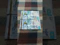 Две БАНКНОТЫ 10000 ТЕНГЕ на байковой поверхности 26-го Мая
