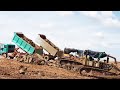 Soil unloading Dump truck stuck in mud recovery by dozer