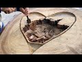 Process restoring damaged wooden panels by skillful carpenter  heart mounted design on table top