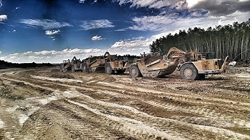 Three twin engine scrapers triple push pull