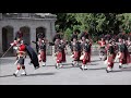 Black Watch Pipes and Drums lead the Royal Guard out of Balmoral Castle with pony mascot Cruachan IV