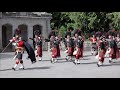 Black watch pipes and drums lead the royal guard out of balmoral castle with pony mascot cruachan iv