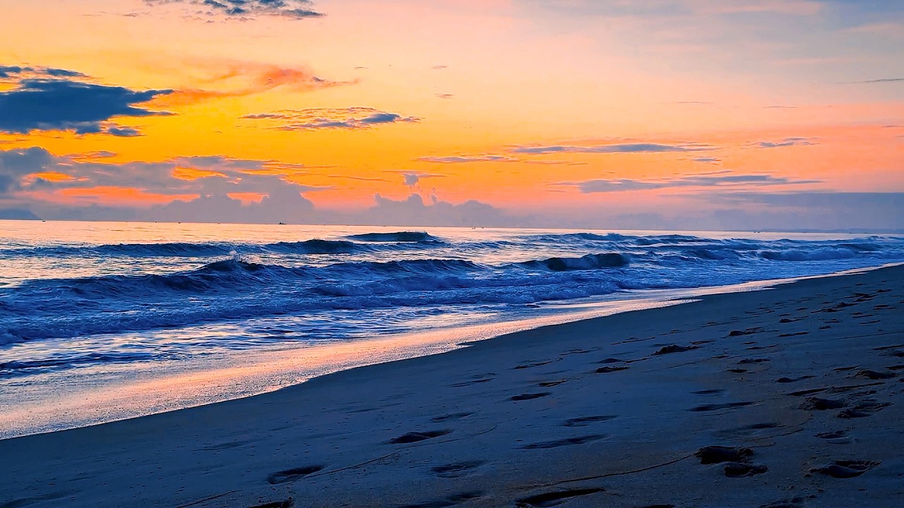 Serene Beach at Bright Sunset with Gentle Ocean Waves and Calm Sky