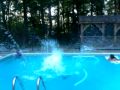 Shayne does a back-flop into the pool