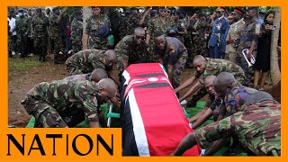 KDF soldiers lower coffin containing the body of Sergeant Rose Nyawira into the grave Resimi