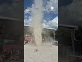 Dust Devil Throws Umbrella At Construction Site
