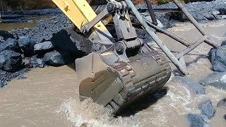 excavator working in a sand mine dredging and washing it in the mine river flow - 4k