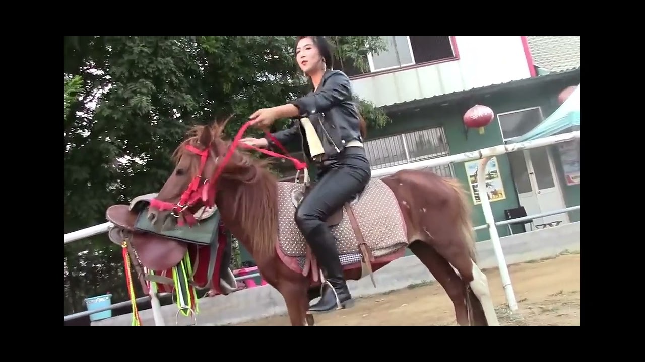 Angry woman beating her lazy horse