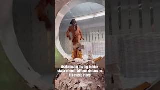 Asake using his leg to kick stack of multi billions dollars on his music video