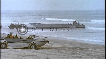 Marines off load equipment from vehicles and two LCM-8s pushed by a bulldozer at ...HD Stock Footage