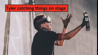 Tyler Joseph catching things on stage