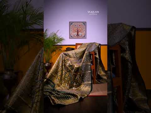 A timeless masterpiece crafted in rich bottle green, adorned with elegant gold zari floral weaving.