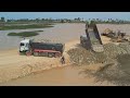 New project showing first starting land filling bulldozer komatsu d58p working push stone in water