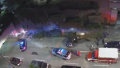 Cars are seen wiping out on exit ramp into downtow...