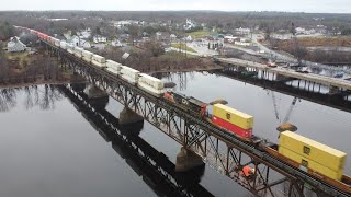Awesome 4K Aerial View! Huge Stack Train CN 121 w/DPU Crossing Bridge at Chipman, NB at Track Speed