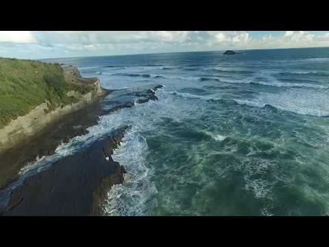 Aerial along the iron sand, Muriwai surf spot, Auckland West, New Zealand.