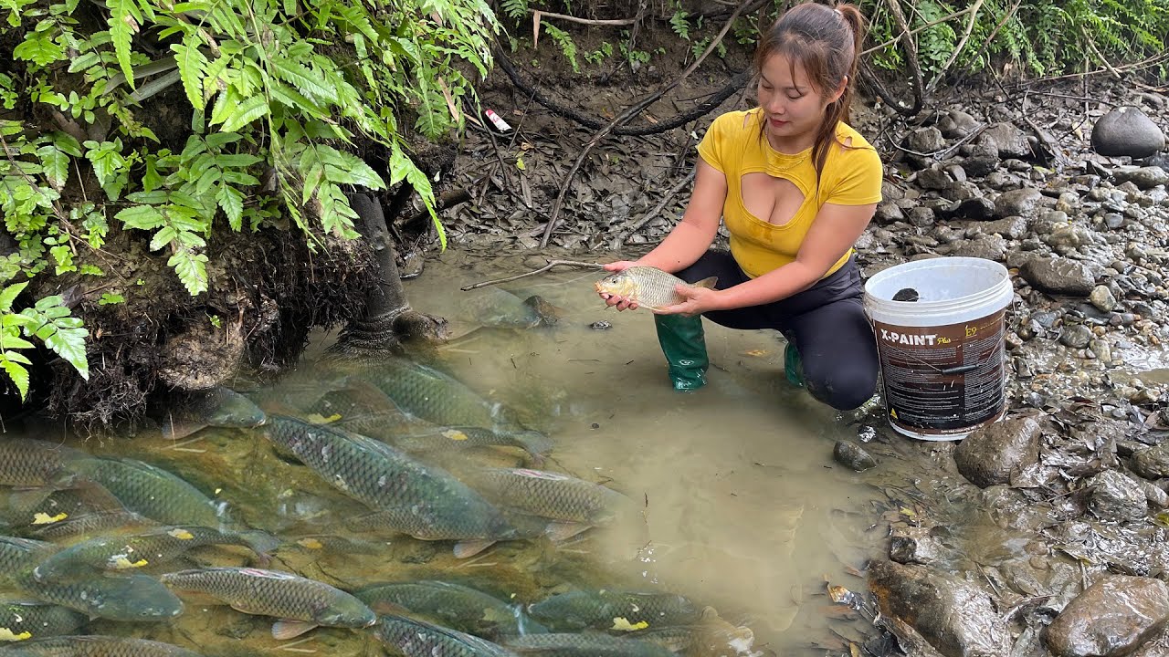 The Girl Fishing, Fishing In Cold Winter In A Dried-Up Lake. Harvesting Many Natural Fish