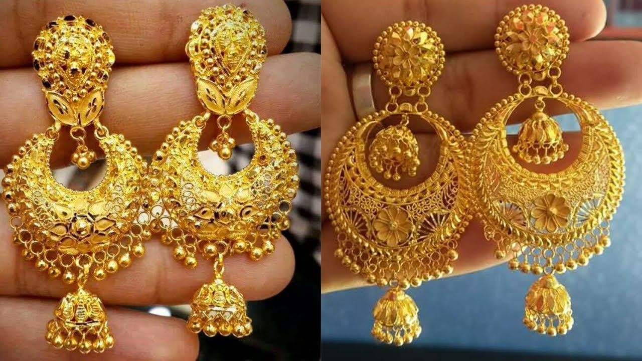 Nanda Gold - Mesmerising design with a touch of the antique tone . The gold  Chandbali earrings having a beautiful nakshi work adorned with goddess  Laxmi embellished on leaf motifs at the