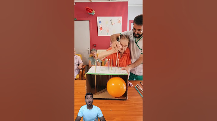 Players push long pins through a cardboard box attempting to pop the balloon!