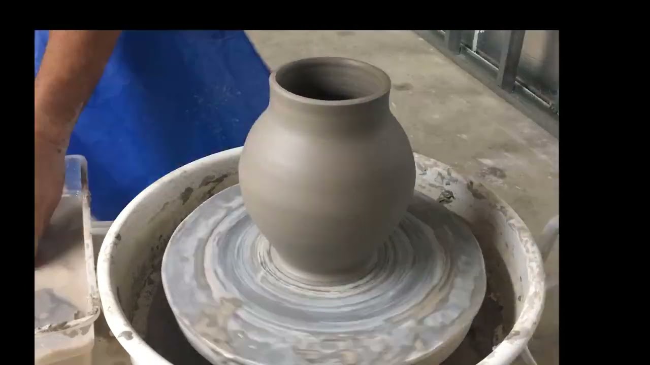Vessel making.  Wheel throwing demonstration.  Shaping the clay cylinder.