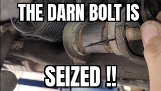 Seized control arm bolt removal from a rotted control arm.