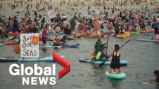 G7 summit: Hundreds of surfers stage paddle-out protest to push for ocean health
