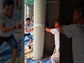 wrapping white plastic stretch film around round concrete pillar for protection in construction work