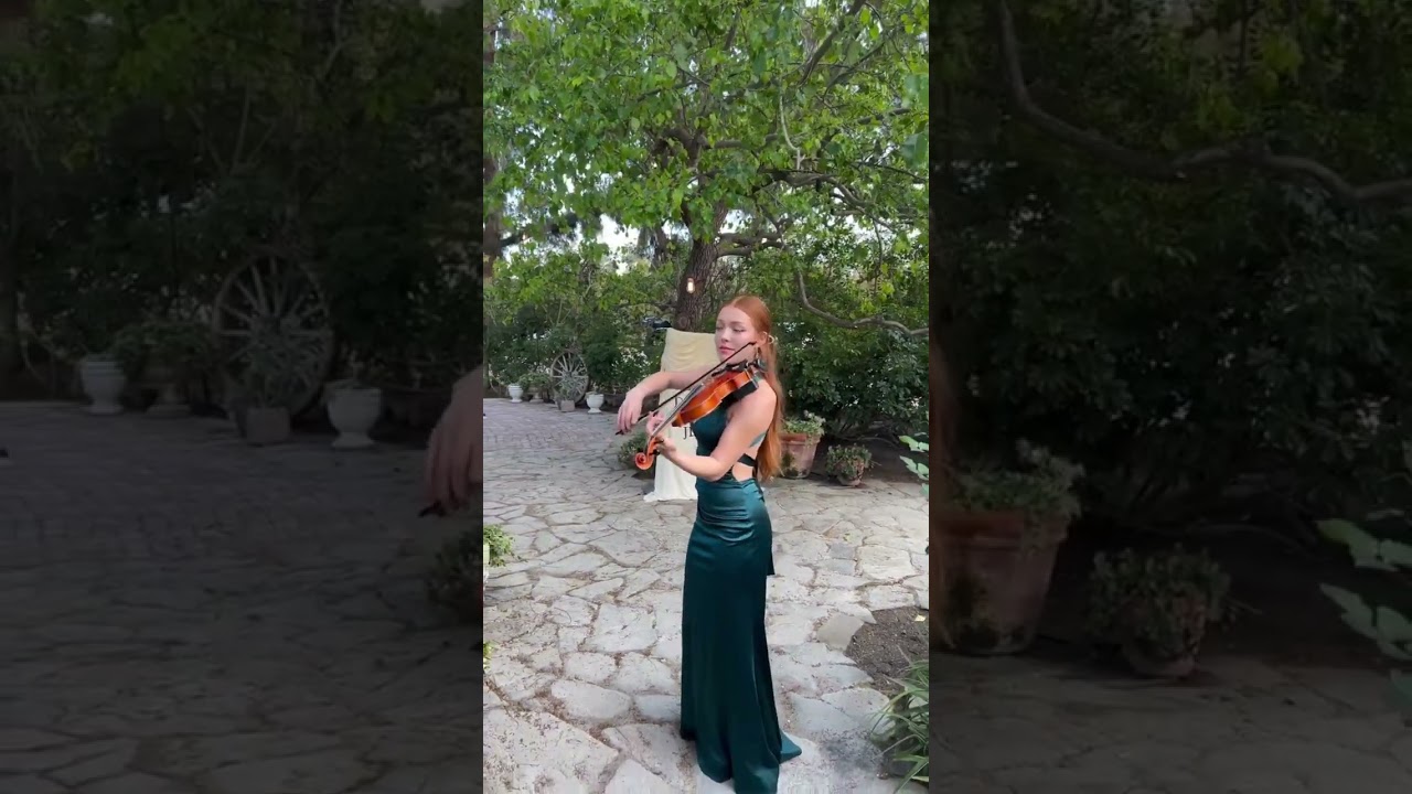 Katie giving an elegant strolling violin performance at a live wedding