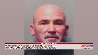 Wanted man accused of killing deputy in shootout on US 52 near North Carolina border