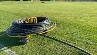 Panks irrigation team installing pipe on sports field.